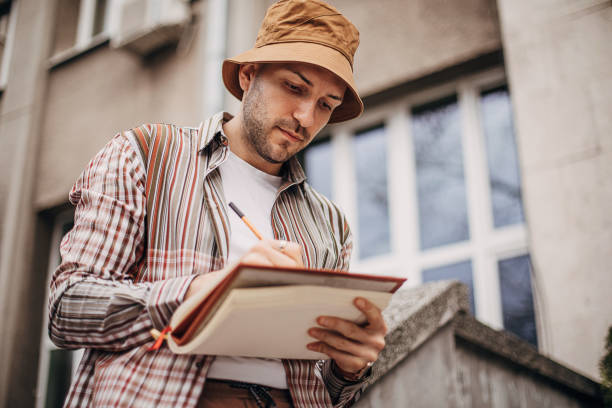 istock Artist drawing outdoors in city 1307606966