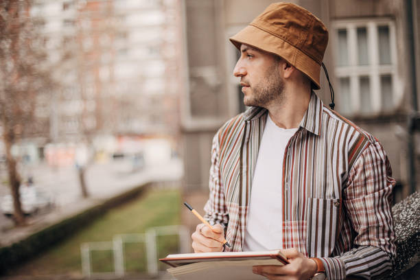 istock Artist drawing outdoors in city 1307607019