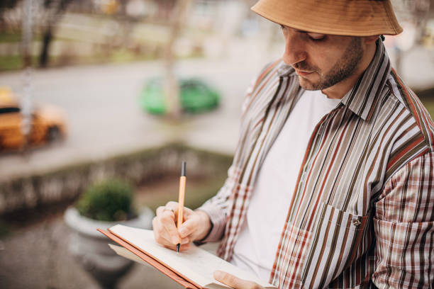 istock Artist drawing outdoors in city 1307607037