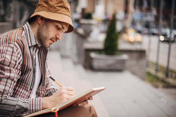 istock Artist drawing outdoors in city 1307607123