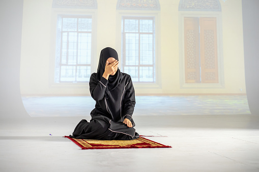 Asian young Muslim woman wearing HIJAB in daily Islamic pray