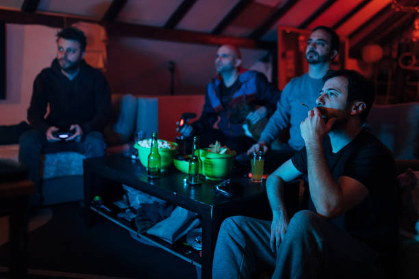 istock Male friends having a competition, while playing video games, cheering, and having so much fun 1307609646