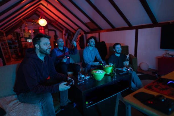 istock Male friends having a competition, while playing video games, cheering, and having so much fun 1307609885