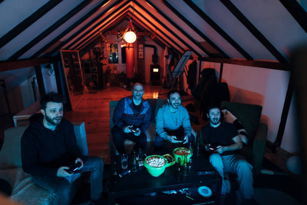istock Male friends having a video game competition, while enjoying the weekend activities 1307609923