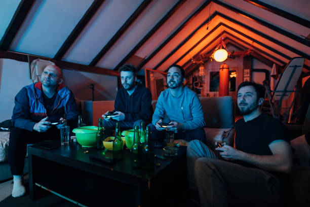 istock Focused mid adult friends spending the night while playing video games 1307610586