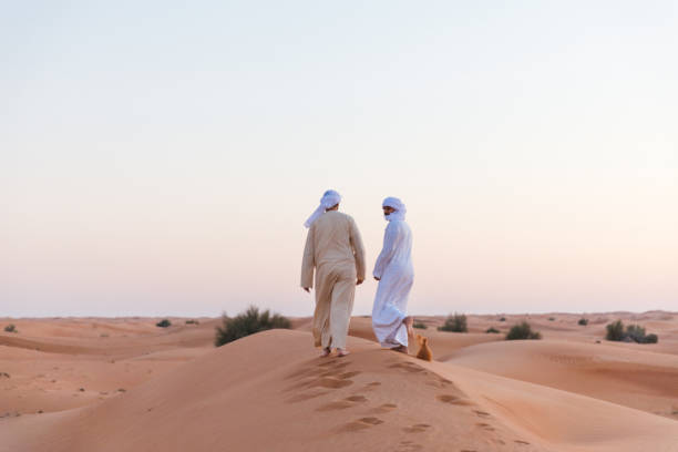istock Arab friends exploring dunes of Dubai 1307613539