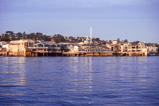 Monterey Bay, California, coastline with Monterey Bay Aquarium in a former fish canning factory. Scanned film, 1998.