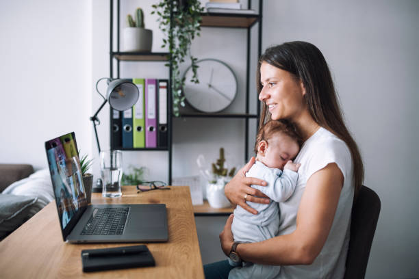 istock Young mother having a video conference while carrying her baby. 1307616262