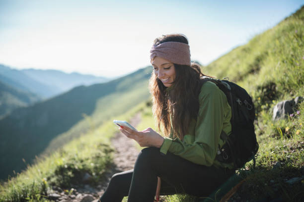 istock Young woman using a technology in the mountain. 1307616265