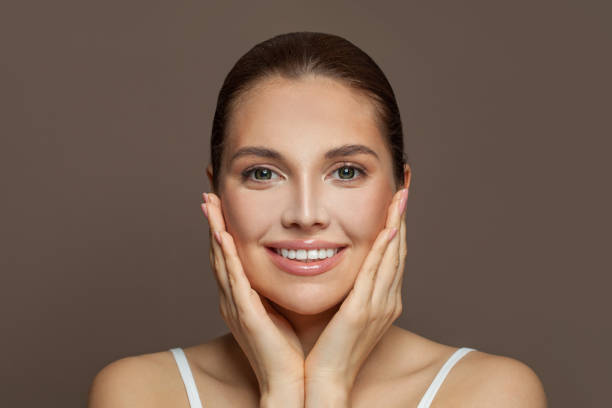 istock Pretty woman face closeup on brown background 1307617938