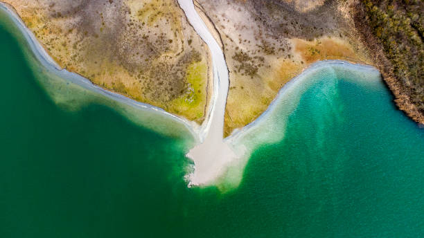 istock Gravel and sand open pit mining, pond with sediments - aerial view 1307625717