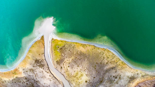 istock Gravel and sand open pit mining, pond with sediments - aerial view 1307625802