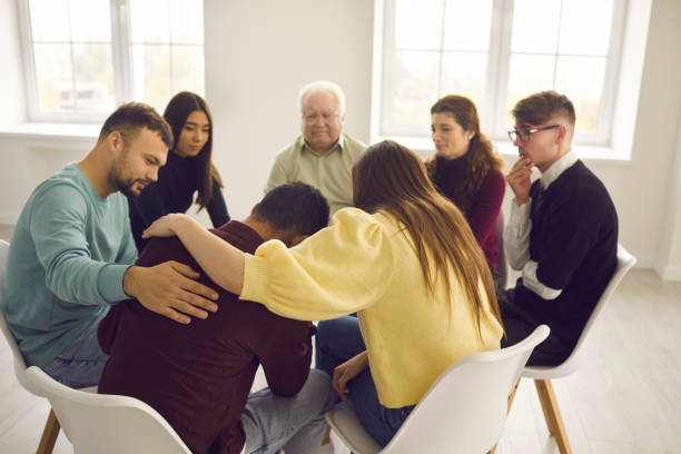 istock Diverse people supporting and comforting a desperate man in a group therapy session 1307626114