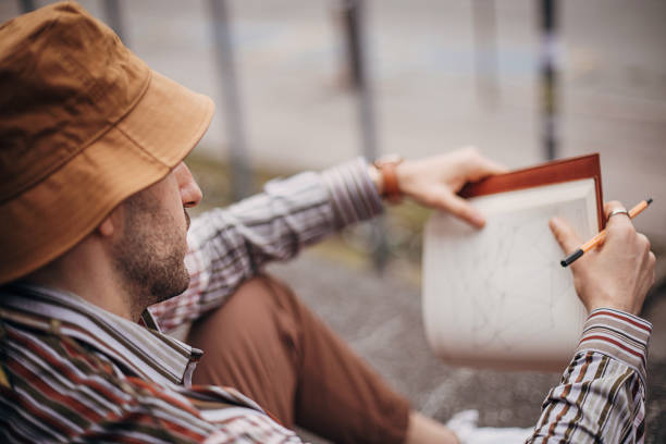 istock Artist drawing outdoors in city 1307630604