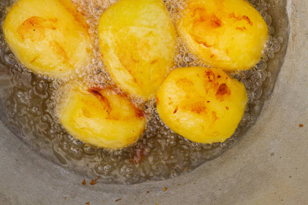 istock Golden potatoes are fried in boiling oil in a cauldron 1307632177