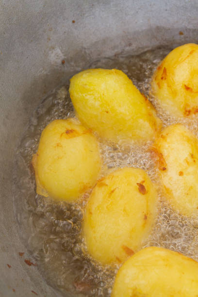 istock Golden potatoes are fried in boiling oil in a cauldron 1307632184