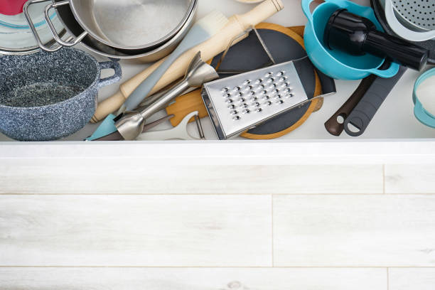 istock Open drawer with different utensils and cutlery in kitchen,  above view, space for text. 1307632386