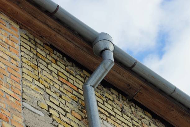 istock gray metal drainpipe on a brown brick wall 1307634747