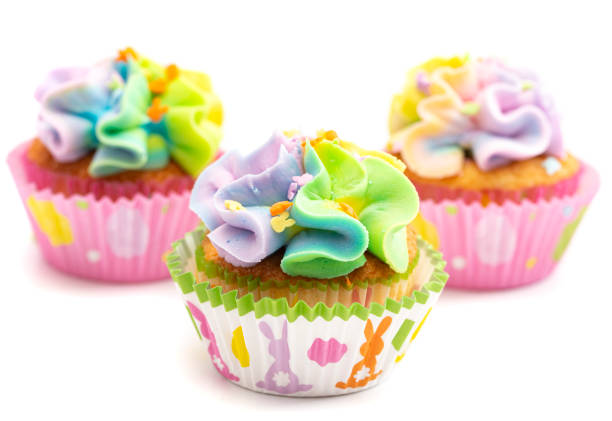 istock Pastel Rainbow Frosted Easter Cupcakes  Isolated on a White Background 1307634824
