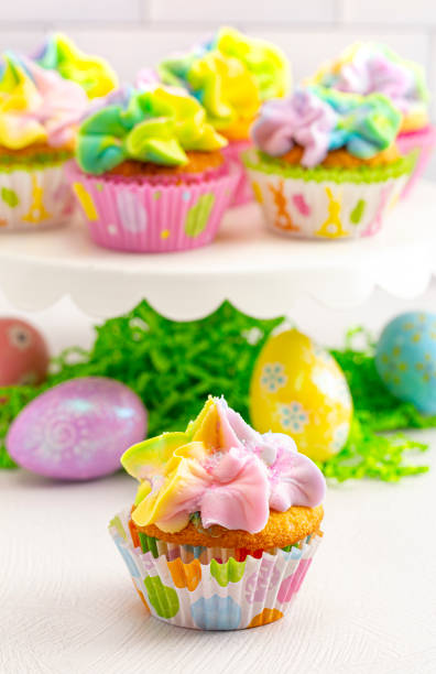 istock Pastel Rainbow Frosted Easter Cupcakes  on a White Kitchen Counter 1307636298