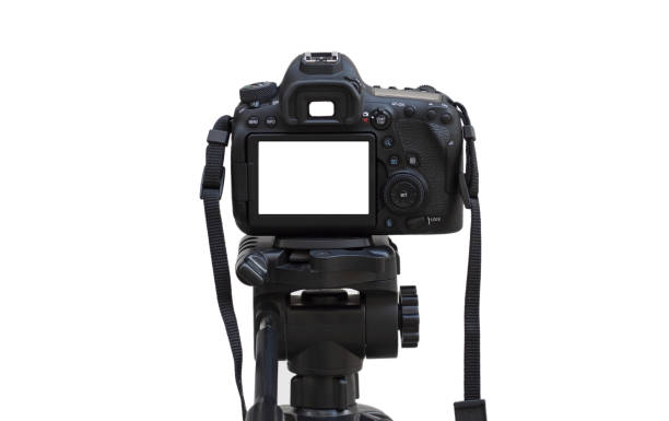 istock Dslr camera with white screen on the tripod isolated on white background. White screen camera 1307638924