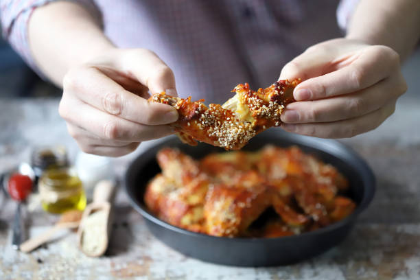 istock The man is eating chicken wings. 1307640234
