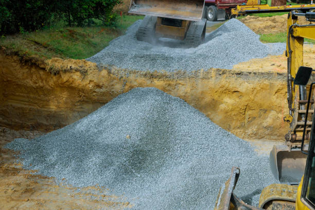 istock Excavator unloading gravel in the construction works of foundation 1307640337