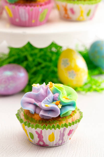istock Pastel Rainbow Frosted Easter Cupcakes  on a White Kitchen Counter 1307641114