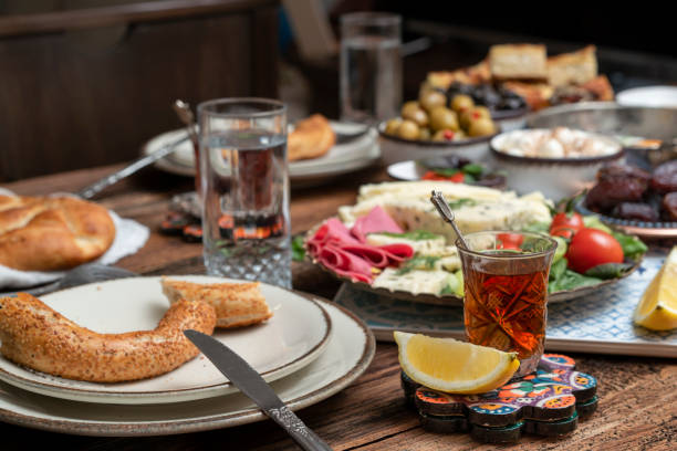 istock Delicious rich Traditional Turkish breakfast include tomatoes, cucumbers, cheese, butter, eggs, honey, bread, bagels, olives and tea cups. Ramadan Suhoor aka Sahur. 1307642356