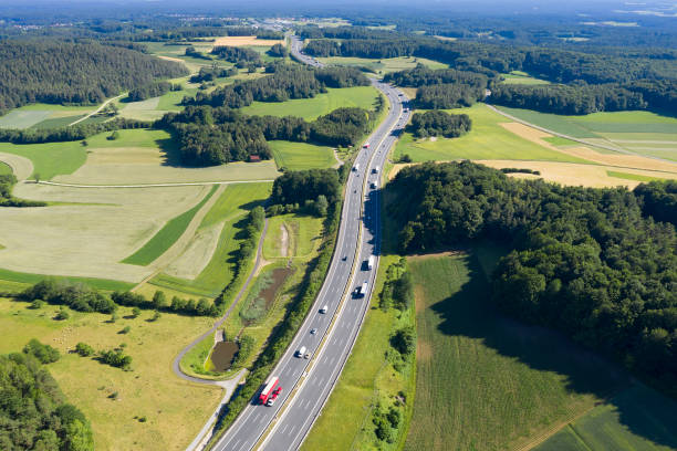 istock Highway with Trucks in Rural Area, Aerial View 1307642584
