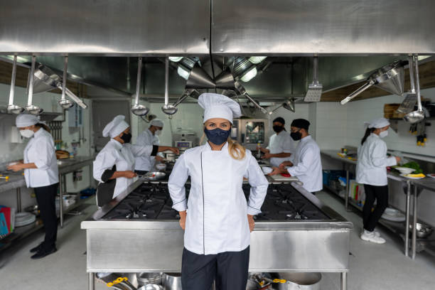 istock Chef working in a kitchen during the pandemic and wearing a facemask 1307643465