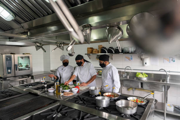 istock Chefs wearing facemasks while cooking at a restaurant during the pandemic 1307643468