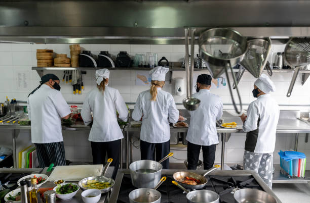 istock Chefs wearing facemasks while working at a restaurant during the pandemic 1307643477