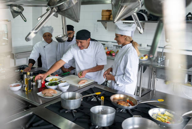 istock Group of students preparing food in a cooking class 1307643480