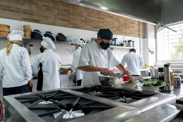 istock Chefs wearing facemasks while working at a restaurant during the pandemic 1307643484