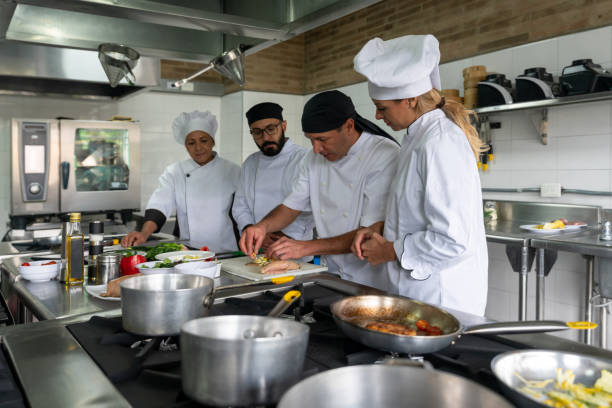 istock Group of cooks attending a cooking class 1307643495