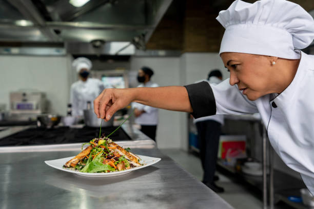 istock Chef working at a restaurant and decorating a plate in the kitchen 1307643496
