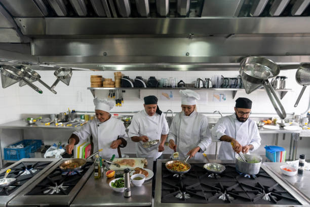 istock Team of chefs cooking at a restaurant 1307643499