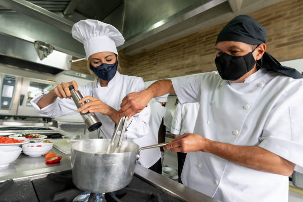 istock Cooks wearing facemasks while cooking at a restaurant during the pandemic 1307643503