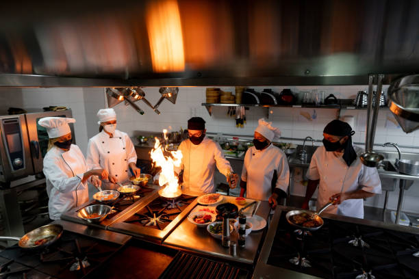 istock Chefs wearing facemasks while cooking at a restaurant during the pandemic 1307643508