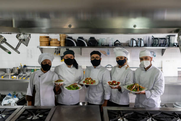 istock Chefs wearing facemasks while working at a restaurant during the pandemic 1307643517