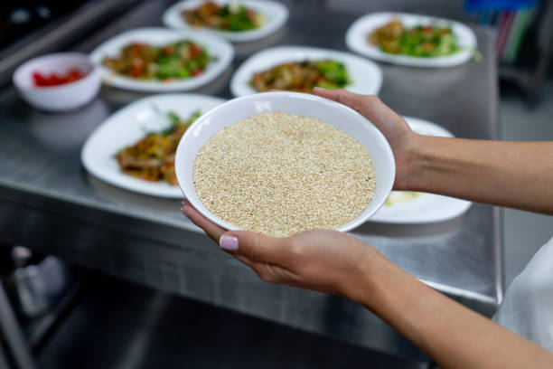 Close-up on a Chef holding a bowl of raw quinoa in the kitchen at a restaurant