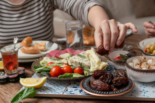 istock Delicious rich Traditional Turkish breakfast include tomatoes, cucumbers, cheese, butter, eggs, honey, bread, bagels, olives and tea cups. Ramadan Suhoor aka Sahur. 1307643587