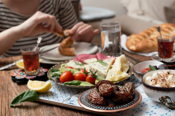 istock Delicious rich Traditional Turkish breakfast include tomatoes, cucumbers, cheese, butter, eggs, honey, bread, bagels, olives and tea cups. Ramadan Suhoor aka Sahur. 1307643588