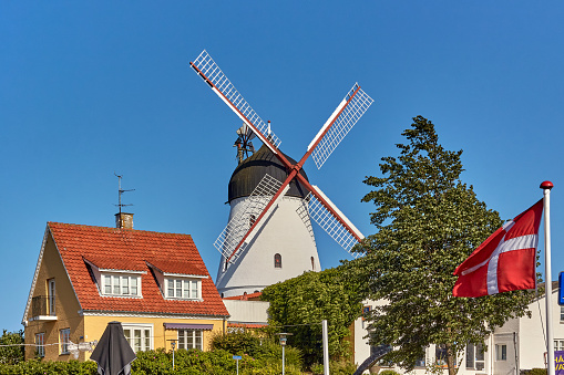 Gudhjem,  Bornholm island, Denmark - June 29, 2019. Gudhjem Windmill (Gudhjem Mølle) located at the top of the village of Gudhjem.