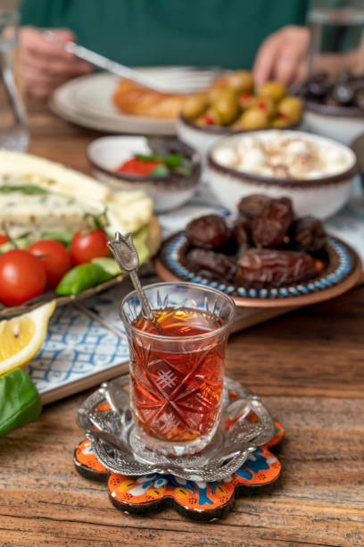 istock Delicious rich Traditional Turkish breakfast include tomatoes, cucumbers, cheese, butter, eggs, honey, bread, bagels, olives and tea cups. Ramadan Suhoor aka Sahur. 1307645533