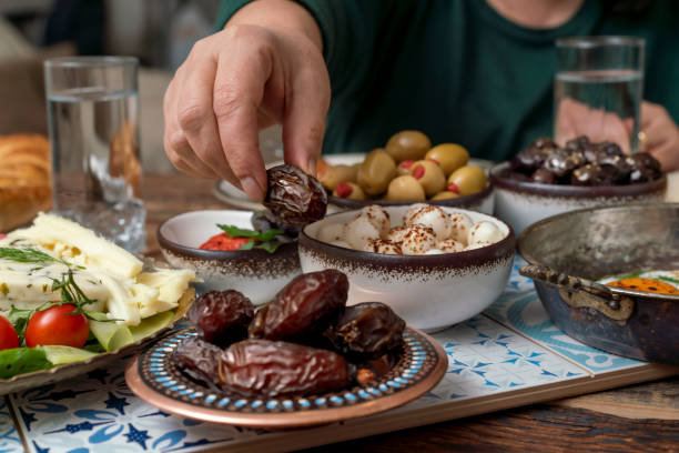 istock Delicious rich Traditional Turkish breakfast include tomatoes, cucumbers, cheese, butter, eggs, honey, bread, bagels, olives and tea cups. Ramadan Suhoor aka Sahur. 1307645762