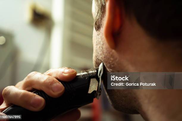 Man Using Electric Razor For Beard Stock Photo - Download Image Now - Electric Razor, Beard, Cutting