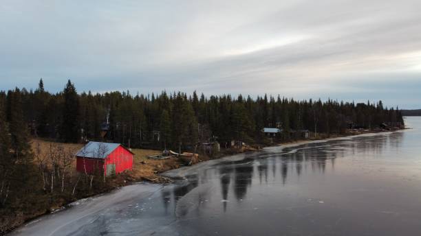 istock Red house near a frozen lake 1307648004