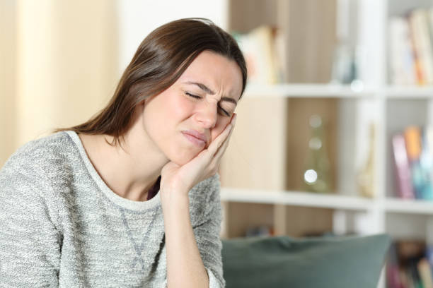 istock Woman suffering toothache at home 1307649301